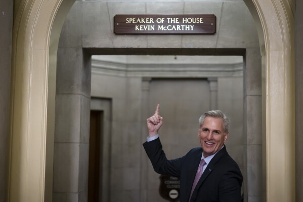 Then-House Speaker Kevin McCarthy of Calif., gestures towards the newly installed nameplate at his office after he was sworn in as speaker of the 118th Congress in Washington, early Saturday, Jan. 7, 2023. (AP Photo/ Matt Rourke, File)