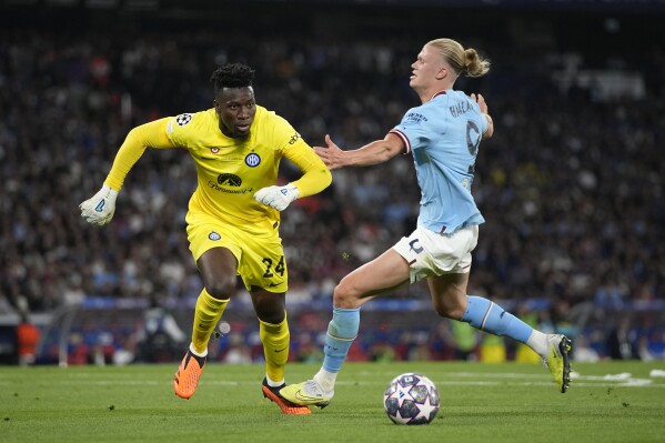 FILE - Manchester City's Erling Haaland is challenged by Inter Milan's goalkeeper Andre Onana during the Champions League final soccer match between Manchester City and Inter Milan at the Ataturk Olympic Stadium in Istanbul, Turkey, Saturday, June 10, 2023. (AP Photo/Emrah Gurel, File)