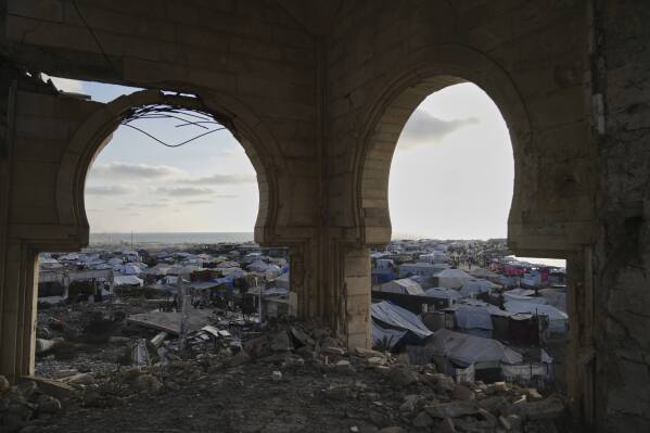 A makeshift tent camp for displaced Palestinians stretches across the port of Gaza City on Thursday, May 22, 2025. (AP Photo/Jehad Alshrafi)