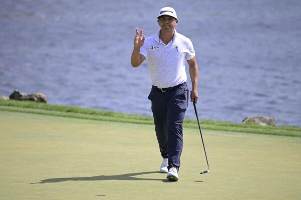 Kurt Kitayama acknowledges the crowd after making a putt for birdie on the 18th green during the second round of the Arnold Palmer Invitational golf tournament, Friday, March 3, 2023, in Orlando, Fla. (AP Photo/Phelan M. Ebenhack)