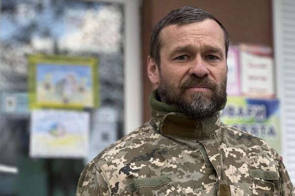 Andrii Kuprash, the head of Babyntsi village north of Kyiv, Ukraine, poses for a photograph in front of the local town hall on April 30, 2022. Russian forces hunted influential Ukrainians like Kuprash, drawing up lists of government officials, journalists and activists in a deliberate, widespread campaign to neutralize resistance through intimidation and violence. Kuprash had been warned the Russians would come for him, and he dug a hole in the woods where he could hide. The Russians found him anyway, beat him and forced him to strip and start digging again, this time to make his own grave. (AP Photo/Erika Kinetz)