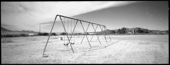 In this Oct. 31, 2021 photo, a view of a lonely playground as the spire of a Latter Day Saints church stands in the background in Bisbee, Ariz. (AP Photo/Dario Lopez-Mills)
