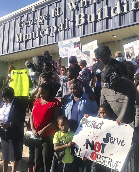 Family and friends of Calvin Wilks Jr., bow their heads in prayer during a press conference on Nov. 2, 2021 in front of the Crestview, Fla., police station. Three Florida police officers were charged with manslaughter in the death Wilks, who was subdued with a stun gun last fall, a state attorney announced Tuesday, June 7, 2022. (Sierra Rains/Northwest Florida Daily News via AP)