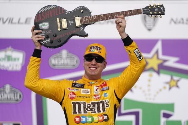 Kyle Busch celebrates with the guitar trophy after winning the NASCAR Xfinity Series auto race at Nashville Superspeedway on Saturday, June 19, 2021, in Lebanon, Tenn. (AP Photo/Mark Humphrey)