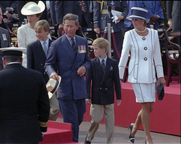 FILE - Prince Charles and Princess Diana escort their children William, left, and Harry, right, onto the Royal stand as VJ-Day commemorations got underway at Buckingham Palace in London, Saturday Aug. 19, 1995. Prince Harry alleged Thursday, March 21, 2024, that the publisher of The Sun tabloid unlawfully intercepted phone calls of his late mother, Princess Diana, and father, now King Charles III, as he sought to expand his privacy invasion lawsuit against News Group Newspapers. (AP Photo/Jacqueline Arzt, File)