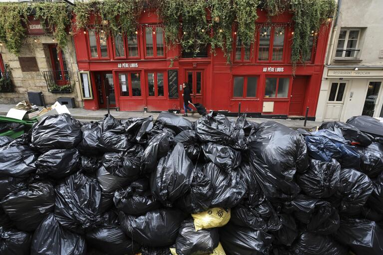 FILE - Uncollected garbage is piled up on a street in Paris, March 20, 2023, during an ongoing strike by sanitation workers. (AP Photo/Aurelien Morissard, File)