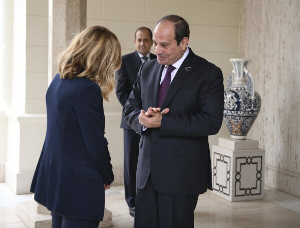 In this photo provided by Egypt's presidency media office, Egyptian President Abdel-Fattah el-Sissi, right, greets Italian Prime Minister Giorgia Meloni at the Presidential Palace in Cairo, Egypt, Sunday, March 17, 2024. (Egyptian Presidency Media Office via AP)
