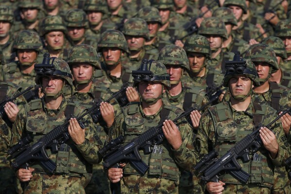 FILE - Serbian Army soldiers perform during a military parade at the military airport Batajnica, near Belgrade, Serbia, on Oct. 19, 2019. Serbia looks set to reintroduce the obligatory military service for its young citizens, the army command said Thursday, Jan. 4, 2024 in a move that comes amid rising tensions in the Balkans. (AP Photo/Darko Vojinovic, File)