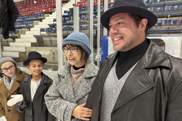 Jason and Roxanne Carrion, from New York, dress up as Rocky and Adrian for the look-alike contest during the RockyFest at Penn Ice Rink in Philadelphia, Friday, Dec. 6, 2024. (AP Photo/Tassanee Vejpongsa)