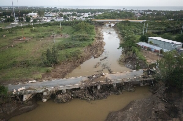 FILE - A bridge is damaged after Hurricane Fiona hit Villa Esperanza in Salinas, Puerto Rico, Sept. 21, 2022. Puerto Rico continues reconstruction work after two devastating hurricanes and a string of strong earthquakes, spending less than 10% of the more than $23 billion available in federal funds, according to a U.S. government report released on Tuesday, Feb. 13, 2024. (APPhoto/Alejandro Granadillo, File)