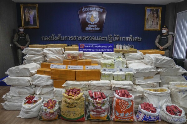FILE - Thai police officers stand behind packages containing seized crystal meth, methamphetamine, heroin during a news conference Bangkok, Thailand, on Sept. 28, 2023.The U.N. drug fighting agency says East and Southeast Asia are awash in record amounts of methamphetamine and other synthetic drugs, originating largely from the cross-border area known as the Golden Triangle, historically known for growing opium and hosting many of the labs that converted it to heroin. (AP Photo/Sakchai Lalit)