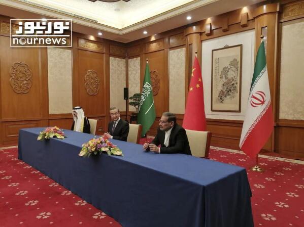In this photo released by Nournews, Secretary of Iran's Supreme National Security Council, Ali Shamkhani, right, China's most senior diplomat Wang Yi, center, and Saudi Arabia's National Security Adviser Musaad bin Mohammed al-Aiban looks on during an agreement signing ceremony between Iran and Saudi Arabia to reestablish diplomatic relations and reopen embassies after seven years of tensions between the Mideast rivals, in Beijing, China, March 10, 2023. In a matter of days, Saudi Arabia carried out blockbuster agreements with the world's two leading powers, signing a Chinese-facilitated deal aimed at restoring diplomatic ties with its arch-nemesis Iran and announcing a massive contract to buy commercial planes from U.S. manufacturer Boeing. (Nournews via AP)