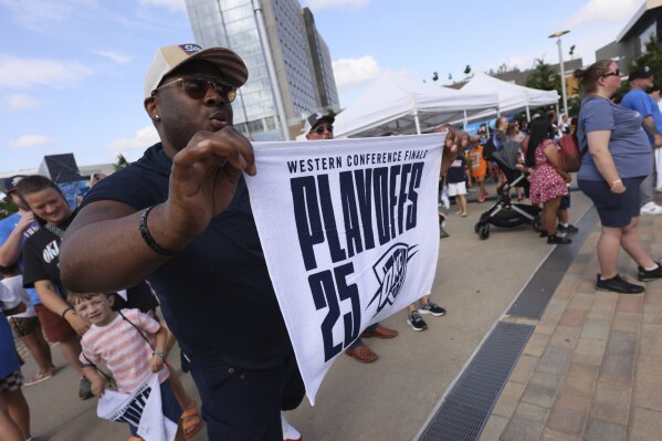A fan holds a towel outside before Game 5 of the Western Conference finals of the NBA basketball playoffs between the Minnesota Timberwolves and Oklahoma City Thunder, Wednesday, May 28, 2025, in Oklahoma City. (AP Photo/Nate Billing)