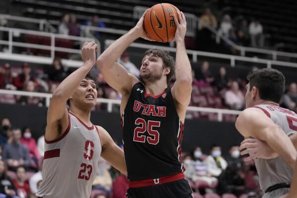 Utah guard Rollie Worster (25) shoots against Stanford forward Brandon Angel (23) during the first half of an NCAA college basketball game in Stanford, Calif., Saturday, Dec. 31, 2022. (AP Photo/Jeff Chiu)
