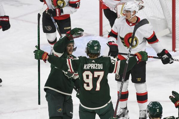 Minnesota Wild left wing Kirill Kaprizov (97) celebrates with center Sam Steel, left, after scoring against the Ottawa Senators as defenseman Nick Holden, right, looks on during the first period of an NHL hockey game, Sunday, Dec. 18, 2022, in St. Paul, Minn. (AP Photo/Craig Lassig)