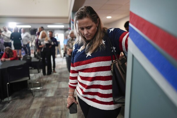 A woman bows her head during a prayer at a watch party for opponents of Issue 1 at the Center for Christian Virtue in Columbus, Ohio, Tuesday, Nov. 7, 2023. (AP Photo/Carolyn Kaster)