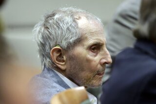FILE - In this Tuesday, March 10, 2020, file photo, real estate heir Robert Durst listens to his defense attorney give their opening statement during his murder trial in Los Angeles. Durst's trail has been delayed for three weeks over fears of the transmission of coronavirus and will stand adjourned until April 6. (AP Photo/Alex Gallardo, Pool, File)