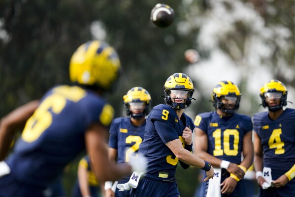 Michigan quarterback J.J. McCarthy (9) throws to wide receiver Cornelius Johnson (6) during practice Friday, Dec. 29, 2023, in Carson, Calif. Michigan is scheduled to play against Alabama on New Year's Day in the Rose Bowl, a semifinal in the College Football Playoff. (AP Photo/Ryan Sun)