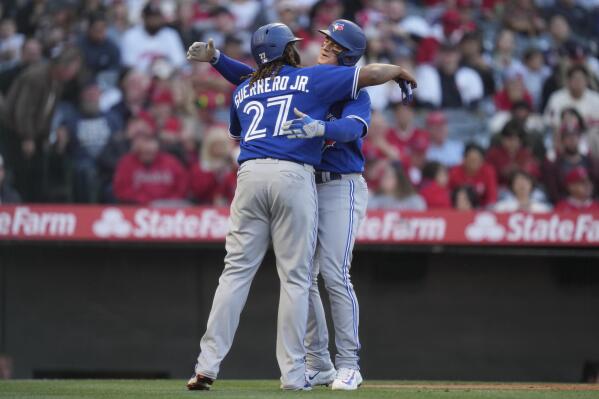 Los Angeles Angels' Mike Trout (27) gives Hunter Renfroe (12) a helmet  after Renfroe hit a home run during the eighth inning of a baseball game  against the Toronto Blue Jays in