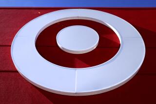 The bullseye logo on the Target store in the South Bay neighborhood of Boston, Monday, Feb. 28, 2022. Target’s seasonal collection for Pride month has been the subject of several misleading posts in recent weeks, with users falsely claiming the retailer is selling “tuck-friendly” swimsuits for kids or in kids’ sizes.  (AP Photo/Charles Krupa)
