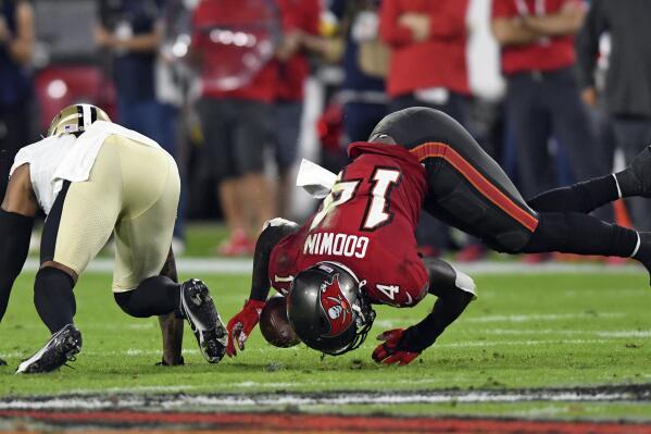 Tampa Bay Buccaneers wide receiver Chris Godwin (14) can't hang onto a pass after getting hit by New Orleans Saints cornerback P.J. Williams (26) during the first half of an NFL football game Sunday, Dec. 19, 2021, in Tampa, Fla. (AP Photo/Jason Behnken)
