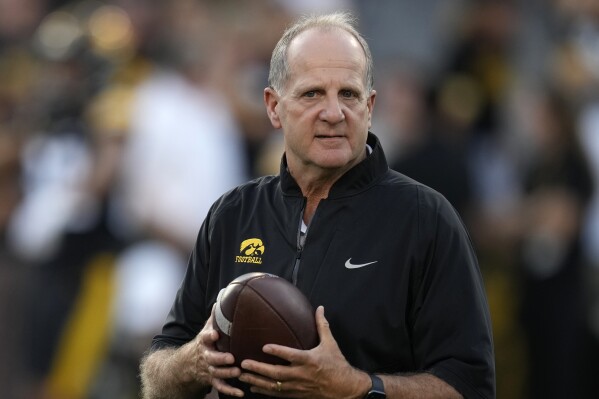 FILE - Iowa defensive coordinator Phil Parker walks on the field before an NCAA college football game against Michigan State, Saturday, Sept. 30, 2023, in Iowa City, Iowa. Parker has been named the recipient of the 2023 Broyles Award, presented annually to the top assistant coach in college football.(AP Photo/Charlie Neibergall, File)