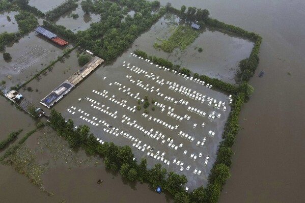 FILE - A private car warehouse is submerged in flood water from River Hindon following excessive rains, in Greater Noida, outskirts of New Delhi, India, July 26, 2023. The devastation of this year's monsoon season in India, which runs from June to September, has been significant. (AP Photo/Piyush Nagpal, File)