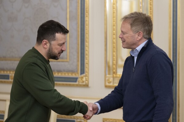 In this photo provided by the Ukrainian Presidential Press Office, Ukrainian President Volodymyr Zelenskyy, left, and Britain's Defence Secretary Grant Shapps shake hands during their meeting in Kyiv, Ukraine, Thursday, March 7, 2024. Britain said Thursday that it would provide 10,000 drones to arm Ukraine in its fight against Russia. (Ukrainian Presidential Press Office via AP)