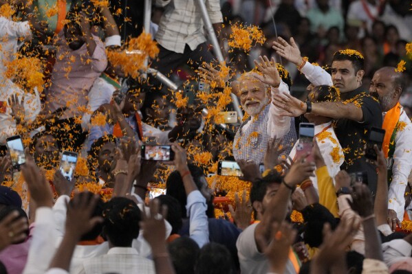 FILE-Indian Prime Minister Narendra Modi greets supporters as he arrives for an election campaign rally of his Bharatiya Janata Party (BJP) in Hyderabad, India, Tuesday, Nov. 7, 2023. From April 19 to June 1, nearly 970 million Indians - or over 10% of the world’s population - will vote in the country's general elections. The mammoth electoral exercise is the biggest anywhere in the world - and will take 44 days to complete before results are announced on June 4. (AP Photo/Mahesh Kumar A. File)