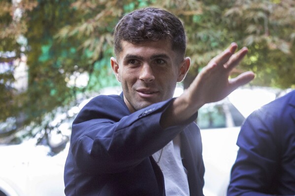United States soccer player Christian Pulisic waves as he arrives in Milan, Italy, Wednesday, July 12, 2023, for medical tests at Italian Serie A soccer team AC Milan before an expected transfer from British club FC Chelsea. (Stefano Porta/LaPresse via AP)