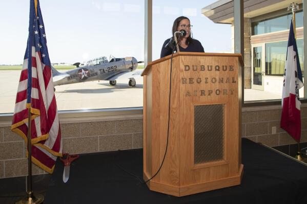 In this Tuesday, July 19, 2022, photo, Dawnelle Gordon speaks during the ribbon-cutting ceremony renaming the Dubuque Regional Airport main terminal in honor of WWII pilot and Dubuque native Capt. Robert L. Martin in Dubuque, Iowa. (Stephen Gassman/Telegraph Herald via AP)