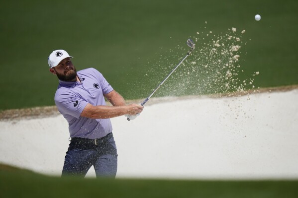 Tyrrell Hatton, of England, hits from the bunker on the second hole during final round at the Masters golf tournament at Augusta National Golf Club Sunday, April 14, 2024, in Augusta, Ga. (AP Photo/Matt Slocum)