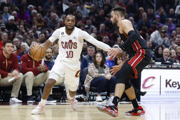 Cleveland Cavaliers guard Darius Garland (10) drives against Miami Heat guard Max Strus (31) during the first half of an NBA basketball game, Sunday, Nov. 20, 2022, in Cleveland. (AP Photo/Ron Schwane)