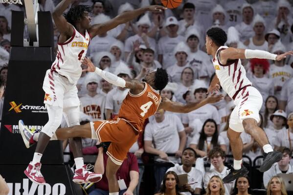 Texas guard Tyrese Hunter, center, loses the ball between Iowa State guard Demarion Watson, left, and guard Tamin Lipsey, right, during the second half of an NCAA college basketball game, Tuesday, Jan. 17, 2023, in Ames, Iowa. Iowa State won 78-67. (AP Photo/Charlie Neibergall)