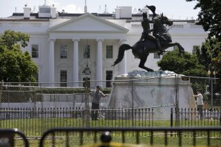 The base of the statue of former president Andrew Jackson is power washed inside a newly closed Lafayette Park, Wednesday, June 24, 2020, in Washington, which has been the site of protests over the death of George Floyd, a black man who was in police custody in Minneapolis. Floyd died after being restrained by Minneapolis police officers. (AP Photo/Jacquelyn Martin)