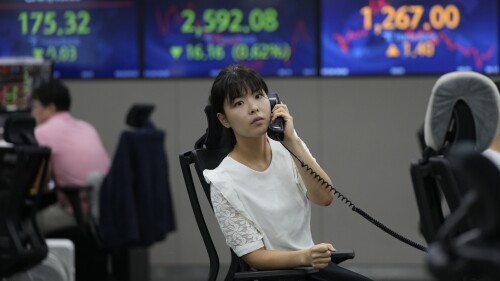 A currency trader talks on the phone at the foreign exchange dealing room of the KEB Hana Bank headquarters in Seoul, South Korea, Thursday, July 20, 2023. Asian shares were mixed Thursday after Japan reported weaker than expected trade data for June, with imports falling nearly 13% from a year earlier. (AP Photo/Ahn Young-joon)