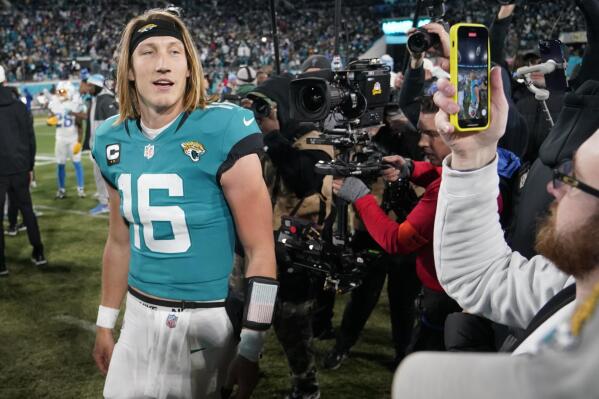 Jacksonville Jaguars quarterback Trevor Lawrence (16) walks off the field after an NFL wild-card football game against the Los Angeles Chargers, Saturday, Jan. 14, 2023, in Jacksonville, Fla. Jacksonville Jaguars won 31-30. (AP Photo/Chris Carlson)