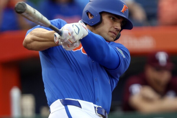 FILE - Florida utility Jac Caglianone hits a single in the first inning of an NCAA baseball game against Texas A&M, March 16, 2024, in Gainesville, Fla. Caglianone tied the NCAA record when he hit a home run for a ninth straight game in a loss at Vanderbilt, Friday, April 19, 2024. (AP Photo/Gary McCullough, File)