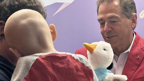 Alabama NCAA college football head coach Nick Saban presents a robotic duck to a cancer patient at Children's Hospital in Birmingham, Alabama on Tuesday, June 6, 2023. (AP Photo/John Zenor)