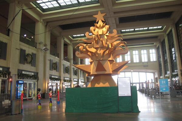 This Nov. 26, 2021 photo shows "The Giving Tree," a Christmas tree display made out of cardboard at Asbury Park NJ's Convention Hall that is delighting many in the seaside town, but dismaying others who miss the fresh-cut natural tree that is usually on display there during the holidays. (AP Photo/Wayne Parry)