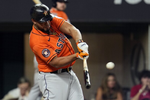 Houston Astros' Jose Abreu hits a three-run home run against the Texas Rangers during the fourth inning in Game 4 of the baseball American League Championship Series Thursday, Oct. 19, 2023, in Arlington, Texas. (AP Photo/Godofredo A. Vasquez)