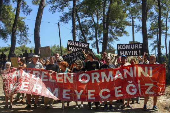 People shout slogans during a protest in Akbelen forest near Ikizkoy, southwestern Turkey, Sunday, July 30, 2023. Environmental activists and local residents are protesting against the demolition of trees in Akbelen forest and the construction of a coal mine in its terrain. (Kenan Gurbuz/Dia Images via AP)