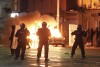 A car burns as Irish policemen stand at the scene of an attack in Dublin city centre, Thursday Nov. 23, 2023. A 5-year-old girl is receiving emergency medical treatment in a Dublin hospital following an attack on Thursday that involved a knife. A woman and two other children were injured. Irish police said they weren't treating the case as terror-related, and that a man in his 50s, who was also hospitalized with serious injuries, is a “person of interest.” (Brian Lawless/PA via AP)