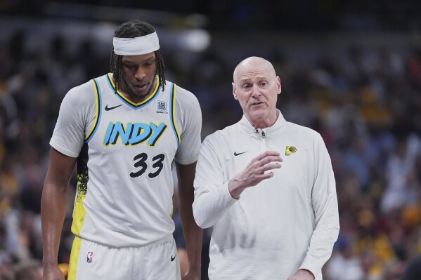 Indiana Pacers center Myles Turner (33) talks to head coach Rick Carlisle in the second half of Game 4 against the Cleveland Cavaliers in the Eastern Conference semifinals of the NBA basketball playoffs in Indianapolis, Sunday, May 11, 2025. (AP Photo/Michael Conroy)