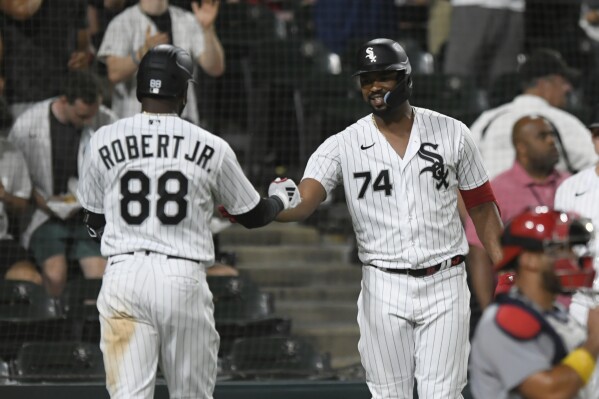 Chicago White Sox's Luis Robert Jr. (88) celebrates with teammate Eloy Jimenez (74) after hitting a solo home run during the seventh inning of a baseball game against the St. Louis Cardinals, Friday, July 7, 2023, in Chicago. (AP Photo/Paul Beaty)
