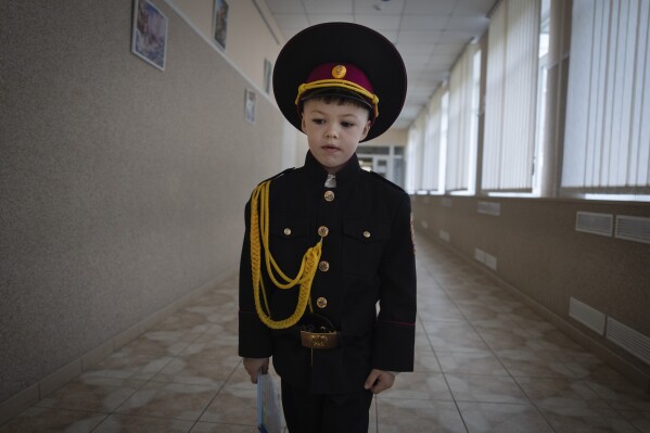 A young cadet goes to his first lesson on the first day of school at a cadet lyceum in Kyiv, Ukraine, Monday, Sept. 4, 2023. (AP Photo/Efrem Lukatsky)