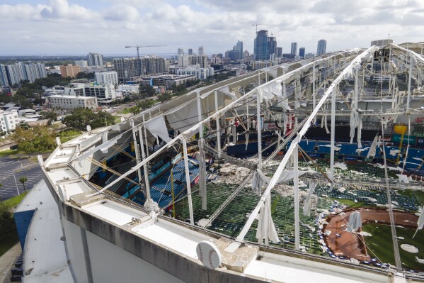 The roof of the Tropicana Field is damaged the morning after Hurricane Milton hit the region Oct. 10, 2024, in St. Petersburg, Fla. (AP Photo/Julio Cortez, File)