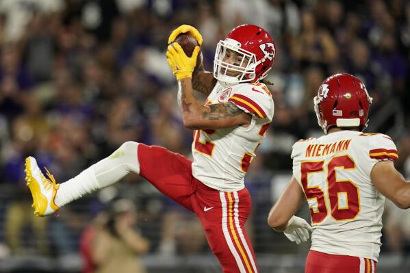 Kansas City Chiefs free safety Tyrann Mathieu, left, intercepts a pass attempt in front of teammate Ben Niemann in the first half of an NFL football game against the Baltimore Ravens, Sunday, Sept. 19, 2021, in Baltimore. (AP Photo/Julio Cortez)