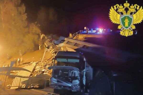 In this photo released by Moscow Interregional Transport Prosecutor's Office telegram channel on Sunday, June 1, 2025, emergency employees work at a damaged bridge in Russia's Bryansk region, which borders Ukraine. (Moscow Interregional Transport Prosecutor's Office telegram channel via AP)