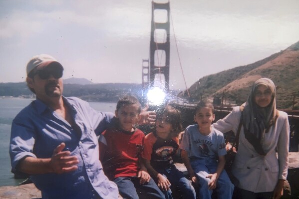 This undated image provided by Fadi Sckak shows a family photo of Abedalla Sckak with his wife Zahra Sckak and children. Abedalla Sckak, 56, died after being shot in the fighting in Gaza last month. He is the father of three American sons, including a U.S. service member. The U.S. coordinated with Israel, Egypt and others to rescue the mother of a U.S. service member who had been trapped by fighting in Gaza. A official said Zahra Sckak made it out of Gaza on New Year's Eve, along with her American brother-in-law.(Fadi Sckak via AP)